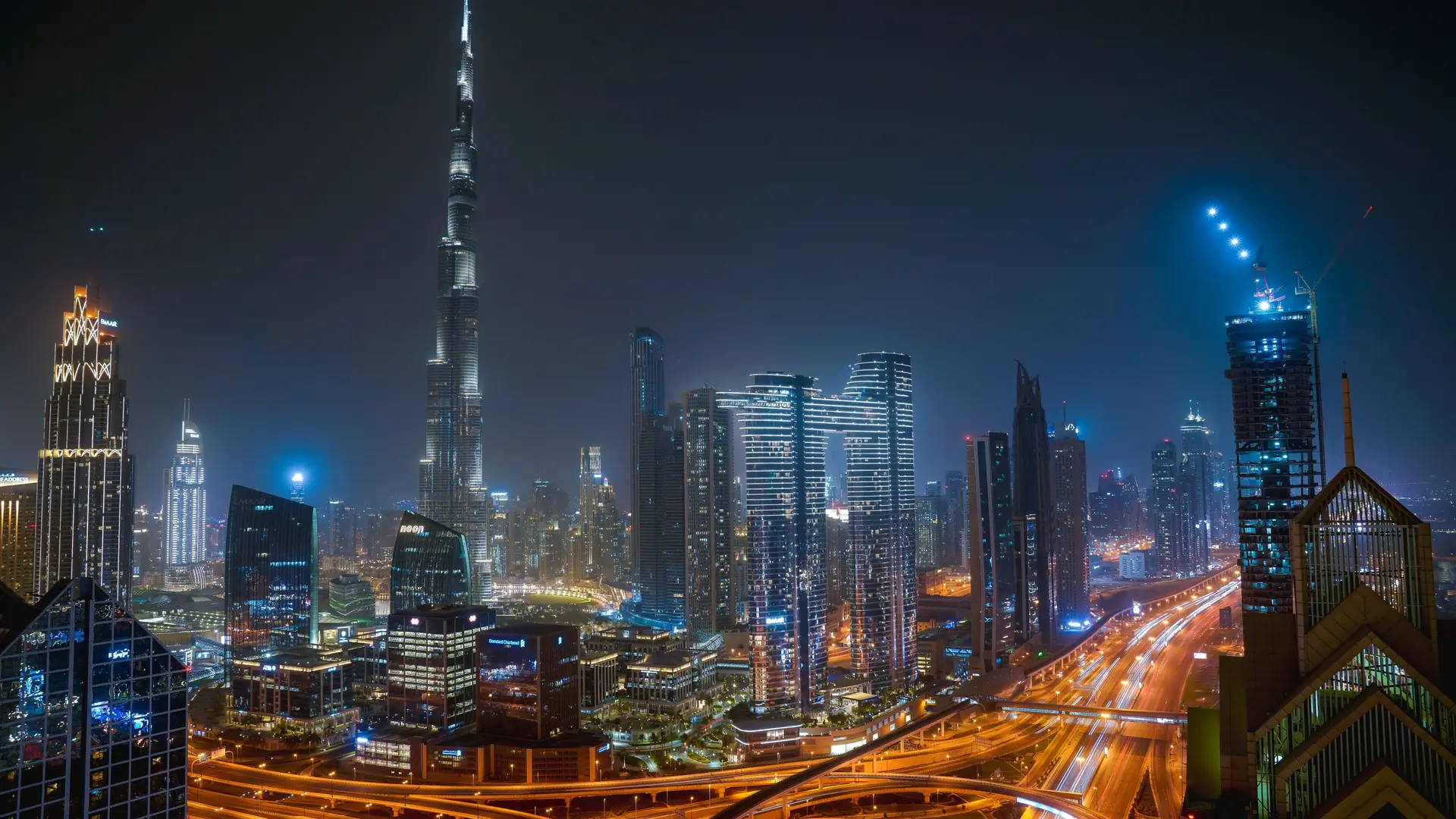 Dubai at night, the roads lit below the towers
