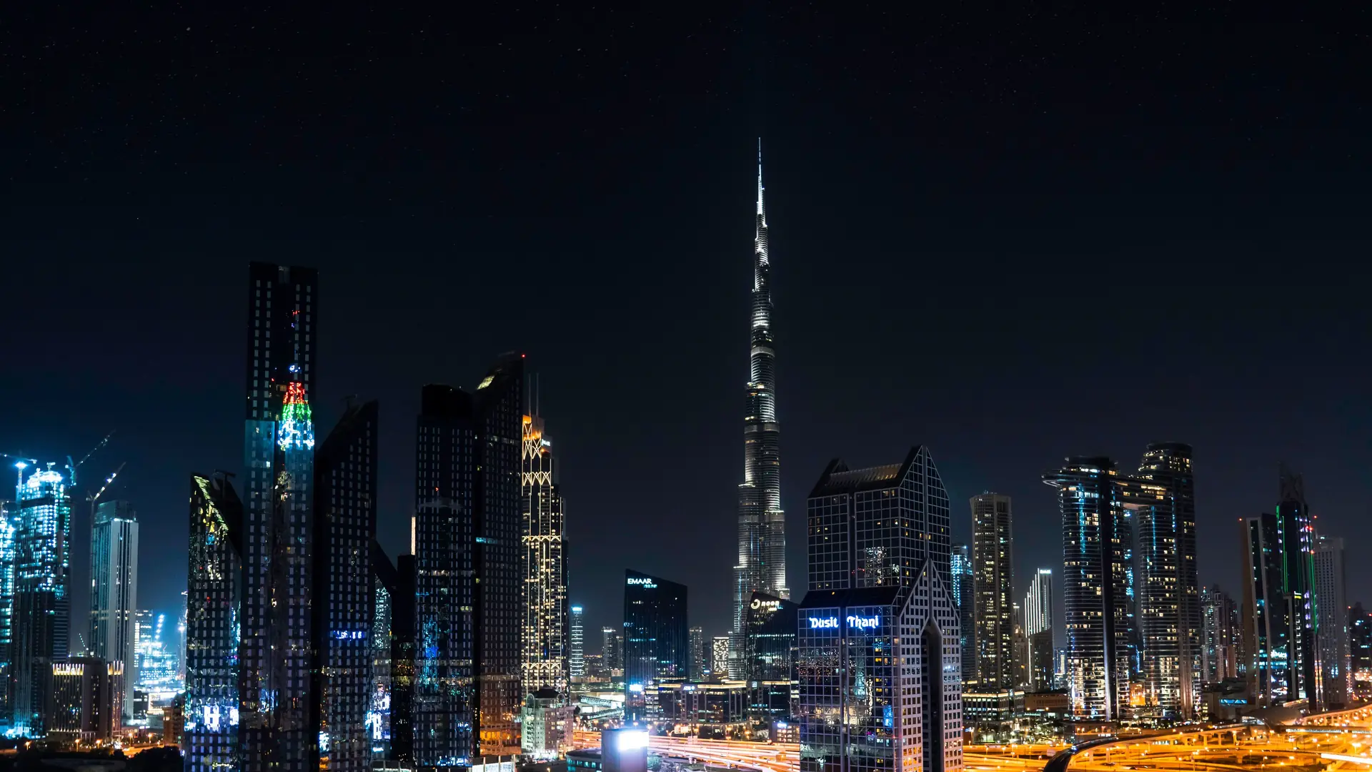 The Dubai skyline lit at night with the Burj Khalifa at its centre