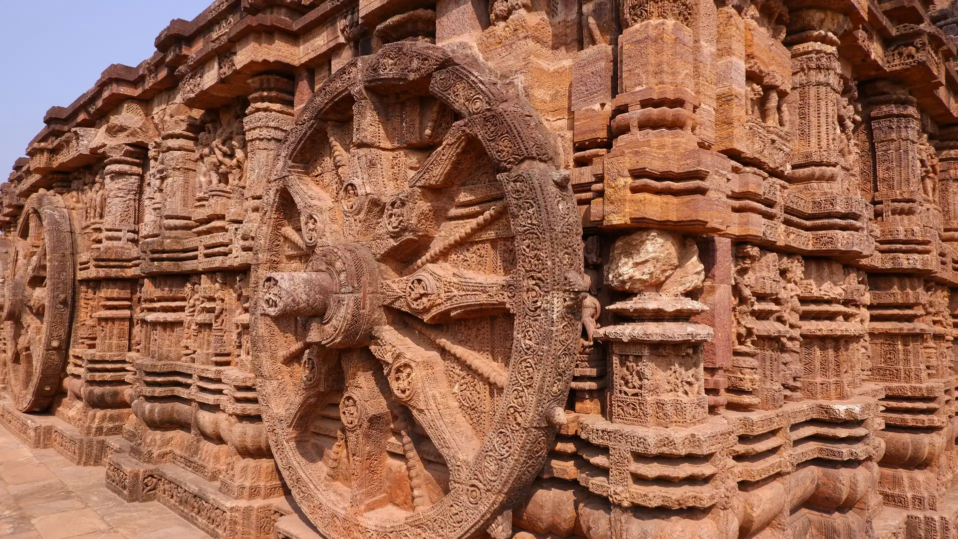 A carved chariot wheel on the laterite wall of the Sun Temple at Konark, Odisha