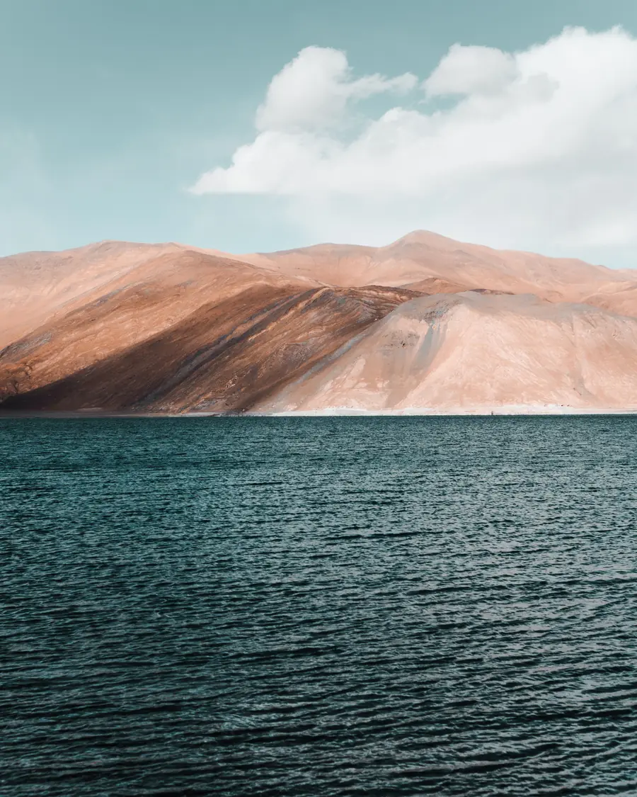 Bare mountains above the dark water of a lake in Ladakh